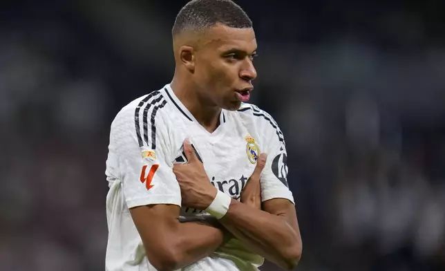 Real Madrid's Kylian Mbappe celebrates after scoring his side's second goal during a Spanish La Liga soccer match between Real Madrid and Alaves at Santiago Bernabeu stadium in Madrid, Spain, Tuesday, Sept. 24, 2024. (AP Photo/Manu Fernandez)