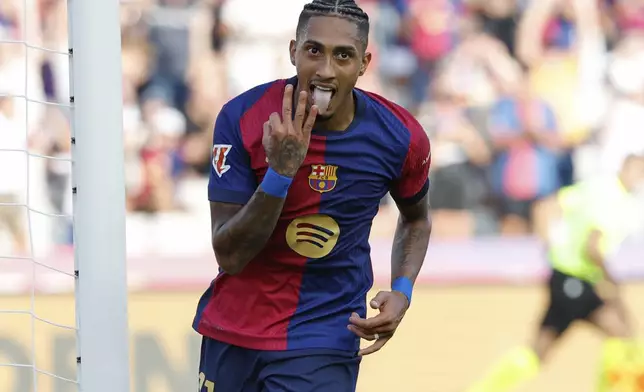 Barcelona's Raphinha celebrates scoring his side's 5th goal during the Spanish La Liga soccer match between FC Barcelona and Valladolid at the Olympic stadium in Barcelona, Spain, Saturday, Aug. 31, 2024. (AP Photo/Joan Monfort)