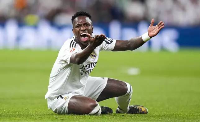 Real Madrid's Vinicius Junior reacts during a Spanish La Liga soccer match between Real Madrid and Alaves at Santiago Bernabeu stadium in Madrid, Spain, Tuesday, Sept. 24, 2024. (AP Photo/Manu Fernandez)