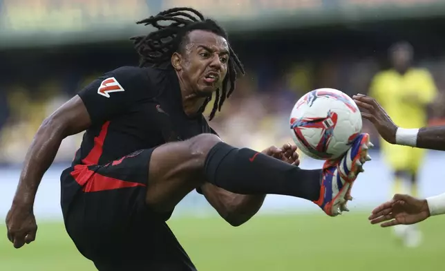 Barcelona's Jules Kounde controls a ball during a Spanish La Liga soccer match against Villarreal at the La Cerámica stadium in Villarreal, Spain, Sunday, Sept. 22, 2024. (AP Photo/Alberto Saiz)