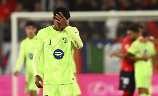 Barcelona's Lamine Yamal reacts at the end of a Spanish La Liga soccer match after loosing against Osasuna at El Sadar stadium in Pamplona, Spain, Saturday, Sept. 28, 2024. (AP Photo/Miguel Oses)