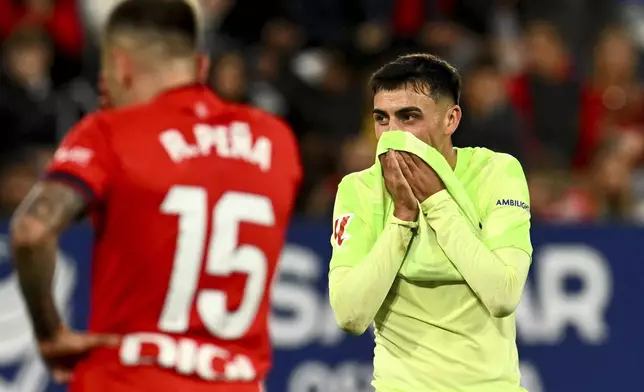 Barcelona's Pedri reacts during a Spanish La Liga soccer match between Osasuna and Barcelona at El Sadar stadium in Pamplona, Spain, Saturday, Sept. 28, 2024. (AP Photo/Miguel Oses)