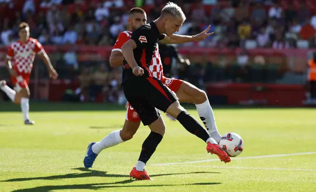 Barcelona's Dani Olmo scores his side's third goal during the Spanish La Liga soccer match between Girona and Barcelona at the Montilivi stadium in Girona, Spain, Sunday, Sept. 15, 2024. (AP Photo/Joan Monfort)