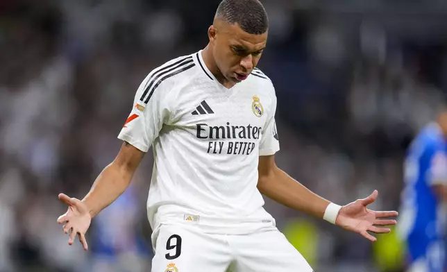 Real Madrid's Kylian Mbappe celebrates after scoring his side's second goal during a Spanish La Liga soccer match between Real Madrid and Alaves at Santiago Bernabeu stadium in Madrid, Spain, Tuesday, Sept. 24, 2024. (AP Photo/Manu Fernandez)