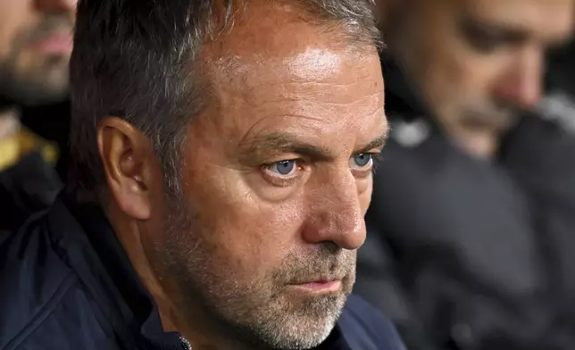 Barcelona's head coach Hansi Flick sits at the bench during a Spanish La Liga soccer match between Osasuna and Barcelona at El Sadar stadium in Pamplona, Spain, Saturday, Sept. 28, 2024. (AP Photo/Miguel Oses)