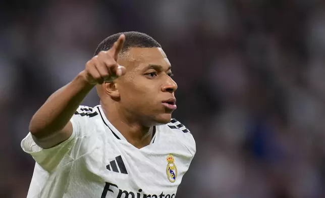 Real Madrid's Kylian Mbappe celebrates after scoring his side's second goal during a Spanish La Liga soccer match between Real Madrid and Alaves at Santiago Bernabeu stadium in Madrid, Spain, Tuesday, Sept. 24, 2024. (AP Photo/Manu Fernandez)