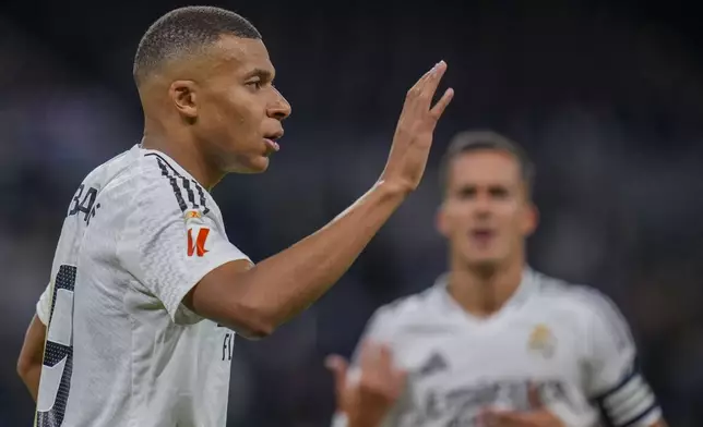 Real Madrid's Kylian Mbappe celebrates after scoring his side's second goal during a Spanish La Liga soccer match between Real Madrid and Alaves at Santiago Bernabeu stadium in Madrid, Spain, Tuesday, Sept. 24, 2024. (AP Photo/Manu Fernandez)