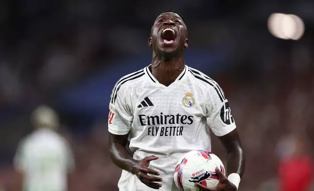 Real Madrid's Vinicius Junior reacts during the Spanish La Liga soccer match between Real Madrid and Betis at the Santiago Bernabeu stadium in Madrid, Spain, Sunday, Sept. 1, 2024. (AP Photo/Pablo Garcia)