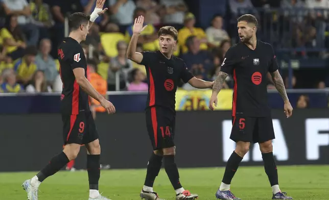 Barcelona's Pablo Torre, center, celebrates with teammates after he scoring his side's 3rd goal against Villarreal during a Spanish La Liga soccer match at the La Cerámica stadium in Villarreal, Spain, Sunday, Sept. 22, 2024. (AP Photo/Alberto Saiz