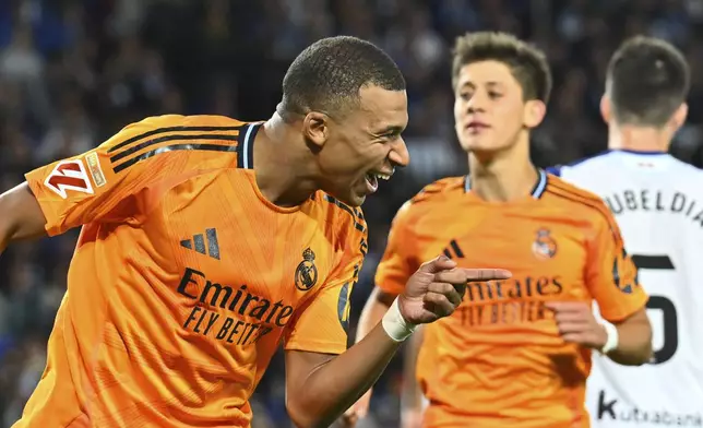 Real Madrid's Kylian Mbappe celebrates after scoring his side's second goal from a penalty kick during a Spanish La Liga soccer match between Real Sociedad and Real Madrid at the Reale Arena in San Sebastian, Spain, Saturday, Sept. 14, 2024. (AP Photo/Miguel Oses)