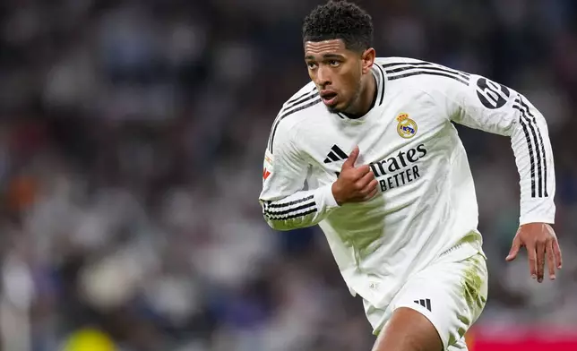 Real Madrid's Jude Bellingham runs during a Spanish La Liga soccer match between Real Madrid and Alaves at Santiago Bernabeu stadium in Madrid, Spain, Tuesday, Sept. 24, 2024. (AP Photo/Manu Fernandez)