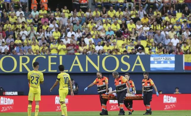 Barcelona's goalkeeper Marc-Andre ter Stegen is removed from the pitch on a stretcher after picking up an injury during a Spanish La Liga soccer match against Villarreal at the La Cerámica stadium in Villarreal, Spain, Sunday, Sept. 22, 2024. (AP Photo/Alberto Saiz)