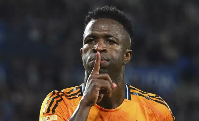 Real Madrid's Vinicius Junior celebrates after scoring the opening goal with a penalty kick during a Spanish La Liga soccer match between Real Sociedad and Real Madrid at the Reale Arena in San Sebastian, Spain, Saturday, Sept. 14, 2024. (AP Photo/Miguel Oses)