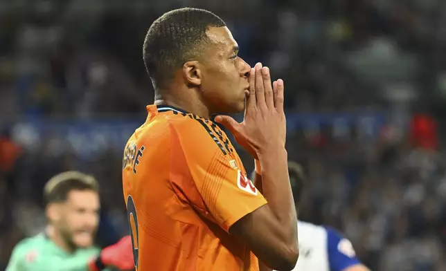 Real Madrid's Kylian Mbappe gestures during a Spanish La Liga soccer match between Real Sociedad and Real Madrid at the Reale Arena in San Sebastian, Spain, Saturday, Sept. 14, 2024. (AP Photo/Miguel Oses)