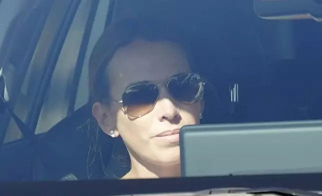 Carolina, the daughter of Edmundo González, is photographed traveling inside a car as she leaves the Torrejón Air Base in Madrid, Spain, Sunday, Sept. 8, 2024. Former Venezuelan opposition presidential candidate Edmundo González has fled into exile after being granted asylum in Spain, delivering a major blow to millions who placed their hopes in his upstart campaign to end two decades of single-party rule. (AP Photo/Andrea Comas)