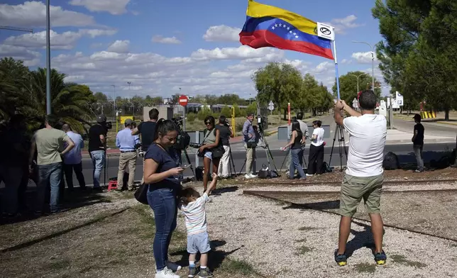 Supporters of Edmundo González wait for his arrival outside the Torrejón Air Base in Madrid, Spain, Sunday, Sept. 8, 2024. Former Venezuelan opposition presidential candidate Edmundo González has fled into exile after being granted asylum in Spain, delivering a major blow to millions who placed their hopes in his upstart campaign to end two decades of single-party rule. (AP Photo/Andrea Comas)