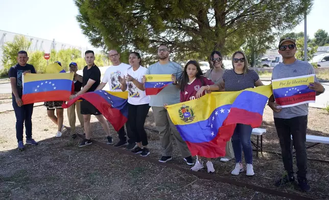 Supporters of Edmundo González wait for his arrival outside the Torrejón Air Base in Madrid, Spain, Sunday, Sept. 8, 2024. Former Venezuelan opposition presidential candidate Edmundo González has fled into exile after being granted asylum in Spain, delivering a major blow to millions who placed their hopes in his upstart campaign to end two decades of single-party rule. (AP Photo/Andrea Comas)