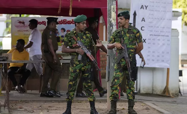 Police commandos stand guard outside a ballot counting center in Colombo, Sri Lanka, Sunday, Sept. 22, 2024. (AP Photo/Eranga Jayawardane)