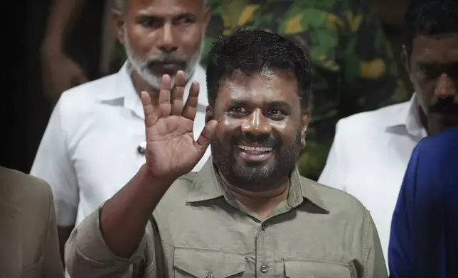 Marxist lawmaker Anura Kumara Dissanayake waves as he leaves from the election commission office after winning Sri Lankan presidential election, in Colombo, Sri Lanka, Sunday, Sept. 22, 2024. (AP Photo/Rajesh Kumar Singh)
