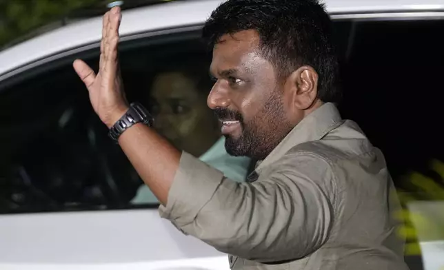 Marxist lawmaker Anura Kumara Dissanayake waves as he arrives at the election commission office after winning Sri Lankan presidential election, in Colombo, Sri Lanka, Sunday, Sept. 22, 2024. (AP Photo/Eranga Jayawardane)