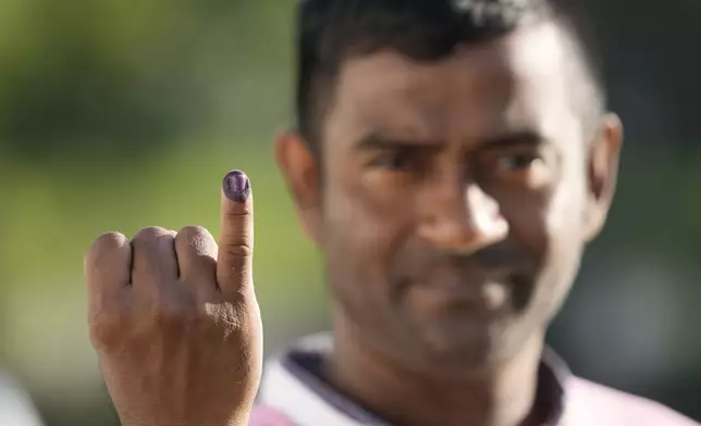 A person shows indelible mark on his finger after casting his vote in Colombo, Sri Lanka, Saturday, Sept. 21, 2024. (AP Photo/Eranga Jayawardane)