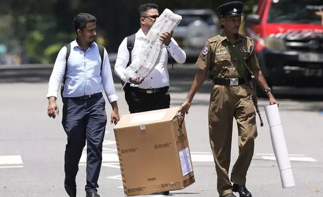 Election officials leave a distribution center after collecting polling material for the upcoming presidential election, in Colombo, Sri Lanka, Friday, Sept. 20, 2024. (AP Photo/Eranga Jayawardena)