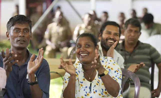 Supporters Marxist lawmaker Anura Kumara Dissanayake cheer as they watch presidential election results on a big electronic screen in Colombo, Sri Lanka, Sunday, Sept. 22, 2024. (AP Photo/Rajesh Kumar Singh)