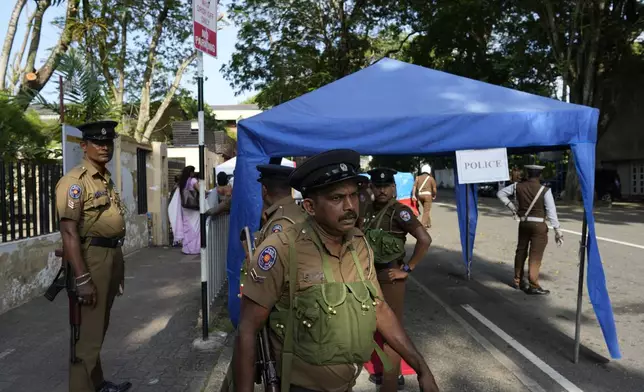 Police officers wait for transport to travel to polling stations ahead of the upcoming presidential election, in Colombo, Sri Lanka, Friday, Sept. 20, 2024. (AP Photo/Eranga Jayawardena)