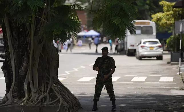 A police officer stands guard outside a polling material distribution center ahead of the presidential election, in Colombo, Sri Lanka, Friday, Sept. 20, 2024. (AP Photo/Eranga Jayawardena)