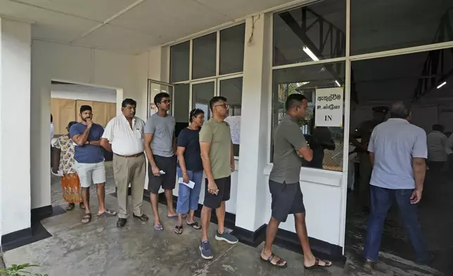 People wait in a queue to casts their votes at a polling station in Colombo, Sri Lanka, Saturday, Sept. 21, 2024. (AP Photo/Rajesh Kumar Singh)