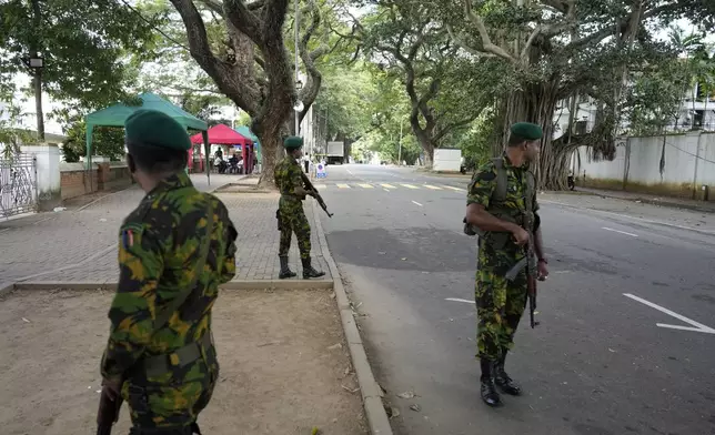 Police commandos stand guard outside a ballot counting center in Colombo, Sri Lanka, Sunday, Sept. 22, 2024. (AP Photo/Eranga Jayawardane)