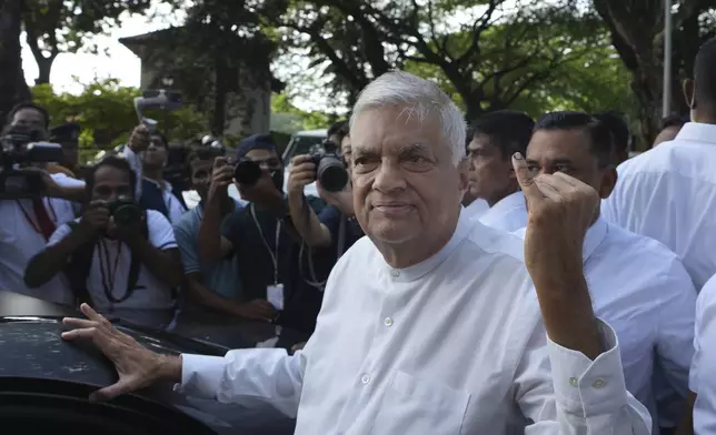 Sri Lankan president and independent presidential candidate Ranil Wickremesinghe shows indelible mark on his baby finger after casting his vote, in Colombo, Sri Lanka, Saturday, Sept. 21, 2024. (AP Photo/Rajesh Kumar Singh)