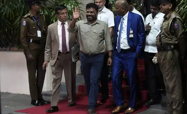 Marxist lawmaker Anura Kumara Dissanayake waves as he departs the election commission office after winning the Sri Lankan presidential election in Colombo, Sri Lanka, Sunday, Sept. 22, 2024. (AP Photo/Eranga Jayawardena)