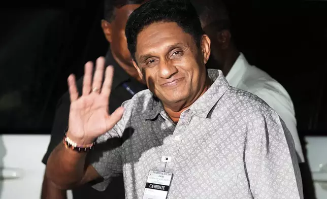 Sri Lankan opposition leader Sajith Premadasa waves as he arrives at the election commission office, in Colombo, Sri Lanka, Sunday, Sept. 22, 2024. (AP Photo/Eranga Jayawardane)