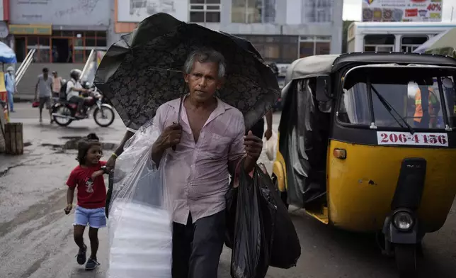 A man sells plastic bags on a street in Colombo, Sri Lanka, Friday, Sept. 13, 2024. (AP Photo/Eranga Jayawardena)