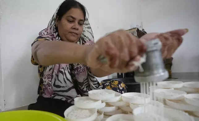 Fathima Shiyama, 48, prepares local delicacies at home, to be sold later from her food cart, in Colombo, Sri Lanka, Tuesday, Sept. 3, 2024. (AP Photo/Eranga Jayawardena)