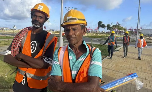 Members of a construction crew take a break from work at the Colombo port, Sri Lanka, Monday, Sept. 16, 2024. (AP Photo/Rajesh Kumar Singh)