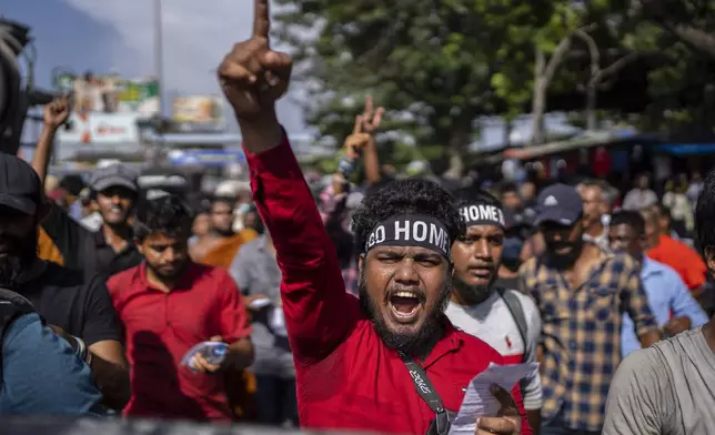 FILE - Protesters shouts slogans demanding acting president and prime minister Ranil Wickremesinghe resign in Colombo, Sri Lanka, in Colombo, Sri Lanka, on July 19, 2022. (AP Photo/Rafiq Maqbool, File)