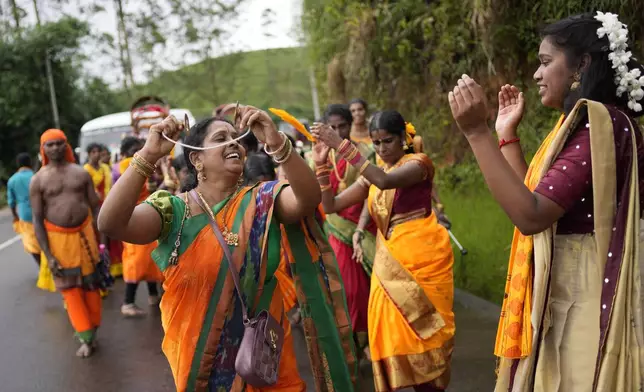 Tea plantation workers dance during a Hindu religious procession in Hatton, Sri Lanka, Sunday, Sept. 8, 2024. (AP Photo/Eranga Jayawardena)