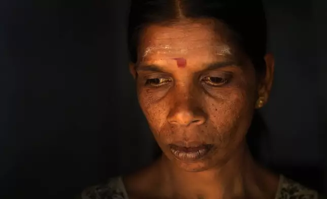 Muthuthewarkittan Manohari, a tea plantation worker, gets ready to go to work in a tea factory in Spring Valley Estate in Badulla, Sri Lanka, Tuesday, Sept. 10, 2024. (AP Photo/Eranga Jayawardena)