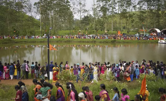 Tea plantation workers and their children take part in a Hindu religious procession in Hatton, Sri Lanka, Sunday, Sept. 8, 2024. (AP Photo/Eranga Jayawardena)