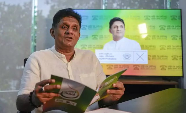 Opposition leader and the presidential candidate of United People's Power Sajith Premadasa speaks holding a copy of his election manifesto during an interview with The Associated Press in Colombo, Sri Lanka, Thursday, Sept. 12, 2024. (AP Photo/Eranga Jayawardena)