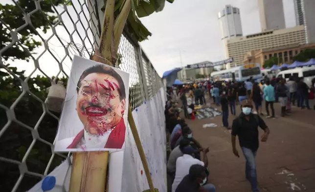 FILE- A vandalized portrait of Prime Minister Mahinda Rajapaksa is seen at a protest site outside President Gotabaya Rajapaksa's office in Colombo, Sri Lanka, Saturday, April 23, 2022. (AP Photo/Eranga Jayawardena, File)