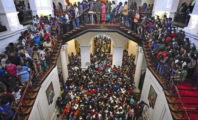 FILE - People storm President Gotabaya Rajapaksa's residence in Colombo, Sri Lanka, Monday, July 11, 2022. (AP Photo/Eranga Jayawardena, File)