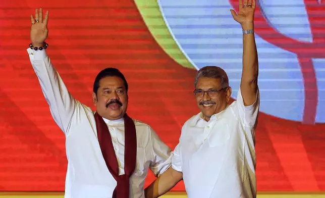 FILE - Mahinda Rajapaksa, left, and his brother Gotabaya Rajapaksa wave to supporters during a party convention held to announce Gotabaya's presidential candidacy in Colombo, Sri Lanka, Aug. 11, 2019. (AP Photo/Eranga Jayawardena, File)