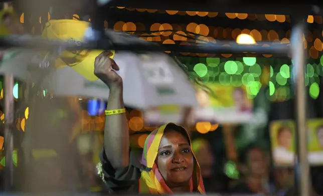 A woman listens to Sajith Premadasa, unseen, the presidential candidate and opposition leader of the Samagi Jana Balawgaya or United People's Power party, at an election rally, in Colombo, Sri Lanka, Wednesday, Sept. 18, 2024. (AP Photo/Rajesh Kumar Singh)