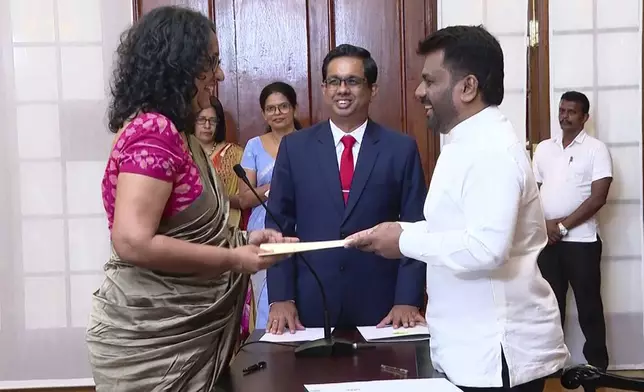 National People's power lawmaker Harini Amarasuriya, 54, left, takes oath for the post of Sri Lanka's Prime Minister in front of President Anura Kumara Dissanayake, in Colombo, Sri Lanka, Monday, Sept. 23, 2024. (Sri Lanka Government Information Department via AP)