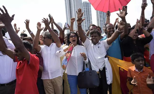 Supporters of Marxist lawmaker Anura Kumara Dissanayake cheer outside the president's office as he arrives to be sworn in as Sri Lanka’s tenth president in Colombo, Sri Lanka, Monday, Sept. 23, 2024. (AP Photo/Eranga Jayawardena)