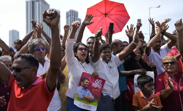 Supporters of Marxist lawmaker Anura Kumara Dissanayake cheer outside the president's office as he arrives to be sworn in as Sri Lanka’s tenth president in Colombo, Sri Lanka, Monday, Sept. 23, 2024. (AP Photo/Eranga Jayawardena)