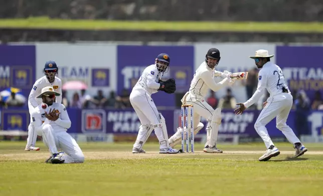 Sri Lanka's captain Dhananjaya de Silva takes a catch to dismiss New Zealand's Tom Blundell during the day three of the second test cricket match between Sri Lanka and New Zealand in Galle , Sri Lanka, Saturday, Sept. 28, 2024. (AP Photo/Eranga Jayawardena)